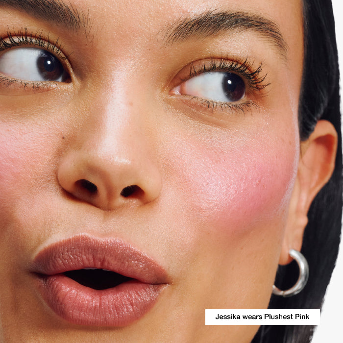 Close-up of a woman's face with makeup, specifically highlighting the color 'Plushest Pink'.
