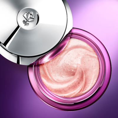 Pink cream in a purple jar with a silver lid on a purple background